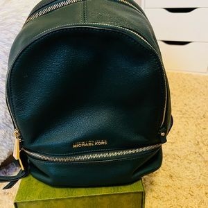 Michael Kors green backpack.